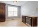 Bright dining area with wine fridge, built-in cabinets, and natural light from large windows at 10321 Sablewood Dr # 108, Raleigh, NC 27617