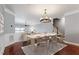 Elegant dining room with chandelier, hardwood floors, and ample seating for entertaining at 10321 Sablewood Dr # 108, Raleigh, NC 27617