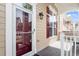 Charming front entrance with a glass-paneled door, red shutters, and a cozy porch at 10321 Sablewood Dr # 108, Raleigh, NC 27617