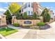 View of The Cottages at Brier Creek entrance sign with stone landscaping and beautiful greenery at 10321 Sablewood Dr # 108, Raleigh, NC 27617