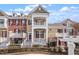 Charming townhome with a double balcony and landscaped yard featuring a black metal fence at 10321 Sablewood Dr # 108, Raleigh, NC 27617