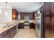 Elegant kitchen boasting granite countertops, stainless steel appliances, and dark wood cabinets at 10321 Sablewood Dr # 108, Raleigh, NC 27617