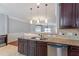 This kitchen features granite countertops, stainless steel appliances, and pendant lighting at 10321 Sablewood Dr # 108, Raleigh, NC 27617