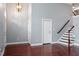 Open-concept living room with high ceilings, hardwood floors, and a staircase at 10321 Sablewood Dr # 108, Raleigh, NC 27617