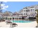 Relaxing outdoor pool area with comfortable lounge seating and surrounding residential buildings at 10321 Sablewood Dr # 108, Raleigh, NC 27617
