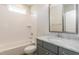 Well-lit bathroom featuring a shower/tub combo, white subway tile, and a gray vanity with marble countertop at 104 Bearwallow Forest Way, Wendell, NC 27591