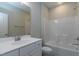 Bright bathroom with white vanity, large mirror, and bathtub-shower combination at 104 Bearwallow Forest Way, Wendell, NC 27591