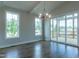 Bright dining area with wood floors, natural light, and sliding glass doors leading to an outdoor space at 104 Bearwallow Forest Way, Wendell, NC 27591