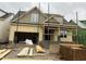 New construction home in progress showcasing its architectural details with open garage and unfinished siding at 104 Bearwallow Forest Way, Wendell, NC 27591