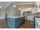 Contemporary kitchen boasts a large center island, stainless steel appliances, and custom white cabinets at 104 Bearwallow Forest Way, Wendell, NC 27591