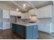 Elegant kitchen with stainless steel appliances, a central island with seating, and modern white cabinetry at 104 Bearwallow Forest Way, Wendell, NC 27591