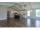 Open-concept kitchen with modern white cabinetry, a central island, and hardwood flooring, perfect for entertaining at 104 Bearwallow Forest Way, Wendell, NC 27591