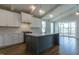 Bright, stylish kitchen featuring a central island with seating, modern appliances, and custom cabinetry at 104 Bearwallow Forest Way, Wendell, NC 27591