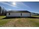Home's backyard featuring a well-maintained lawn and a concrete patio at 107 Faucette Dr, Selma, NC 27576