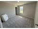 Bright bedroom featuring neutral walls, plush carpet, and a window that provides natural light at 107 Faucette Dr, Selma, NC 27576