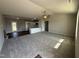 Bright living room flows into an open kitchen with granite countertops and modern cabinetry at 107 Faucette Dr, Selma, NC 27576