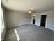 Spacious main bedroom featuring neutral walls, plush carpet, and a ceiling fan at 107 Faucette Dr, Selma, NC 27576