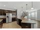 Modern kitchen with dark cabinets, granite countertops, and stainless steel appliances at 111 Daneborg Rd, Durham, NC 27703