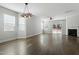 Open living room with hardwood floors, a fireplace, and a sliding glass door at 111 Daneborg Rd, Durham, NC 27703