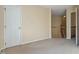 Bonus room with neutral carpet and walls with a doorway and stair access at 11820 Fairlie Pl, Raleigh, NC 27613