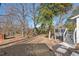 Expansive backyard featuring a treated wood deck, gravel driveway, and black wood mulch at 1204 Donphil Rd, Durham, NC 27712