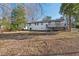 Exterior of home with a deck and large backyard, offering outdoor living and recreational space at 1204 Donphil Rd, Durham, NC 27712
