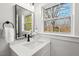 Bathroom featuring a large window, modern vanity, matte black fixtures, and a quartz countertop at 1204 Donphil Rd, Durham, NC 27712