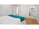 Bedroom with hardwood floors, white walls, and access to the en-suite bathroom at 1204 Donphil Rd, Durham, NC 27712