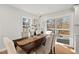 Bright dining area featuring a wooden table, six chairs, and a sliding glass door to the deck at 1204 Donphil Rd, Durham, NC 27712