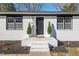 Close-up of a white brick home's front door with manicured shrubs and welcoming entrance at 1204 Donphil Rd, Durham, NC 27712
