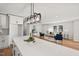 Open concept kitchen featuring a quartz island and modern lighting, seamlessly connected to a cozy living room at 1204 Donphil Rd, Durham, NC 27712