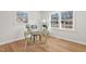 Bright office space with hardwood floors, a modern desk, chair, and multiple windows at 1204 Donphil Rd, Durham, NC 27712