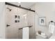 Tiled shower with a glass enclosure, matte black fixtures, and a convenient towel rack at 1204 Donphil Rd, Durham, NC 27712
