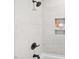 This bathroom features a tiled shower with a black shower head and a built-in alcove at 1204 Donphil Rd, Durham, NC 27712