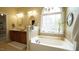 Bright bathroom featuring a large soaking tub and lots of light at 1226 Woodland Church Rd, Wake Forest, NC 27587