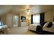 Bedroom features neutral walls and carpet, with a ceiling fan and a black and white color scheme at 1226 Woodland Church Rd, Wake Forest, NC 27587