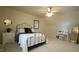 Bedroom features neutral walls and carpet, with a ceiling fan and vanity at 1226 Woodland Church Rd, Wake Forest, NC 27587