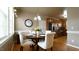 Inviting dining room featuring hardwood floors and views into kitchen at 1226 Woodland Church Rd, Wake Forest, NC 27587
