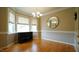 Bright dining room with hardwood floors, large windows, and elegant finishes at 1226 Woodland Church Rd, Wake Forest, NC 27587