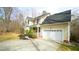 A traditional two-story home with a two-car garage, covered porch, and manicured landscaping at 1226 Woodland Church Rd, Wake Forest, NC 27587