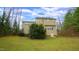 Back exterior view of home with lots of trees and yard space at 1226 Woodland Church Rd, Wake Forest, NC 27587