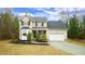 Inviting two-story home featuring a covered porch, bay window, and a two-car garage at 1226 Woodland Church Rd, Wake Forest, NC 27587