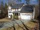 Charming two-story home with an attached garage and a well-maintained front lawn at 1226 Woodland Church Rd, Wake Forest, NC 27587