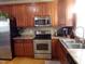 Kitchen featuring stainless steel appliances, wooden cabinets, and a window at 1226 Woodland Church Rd, Wake Forest, NC 27587