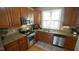 Modern kitchen featuring stainless steel appliances, wood cabinets, and great natural light at 1226 Woodland Church Rd, Wake Forest, NC 27587
