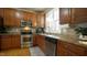 Well-equipped kitchen featuring stainless steel appliances, wood cabinets, and a large window at 1226 Woodland Church Rd, Wake Forest, NC 27587