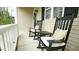 Inviting front porch featuring rocking chairs and white trim at 1226 Woodland Church Rd, Wake Forest, NC 27587