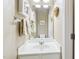 Powder room with white vanity, framed art, and decorative wall hangings, creating a charming space at 12566 Honeychurch St, Raleigh, NC 27614