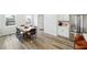 Open concept dining area with modern table, hardwood floors, connecting seamlessly with the kitchen at 1309 Atterlee Ln, Graham, NC 27253