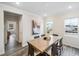 Bright dining room with a large wooden table, modern decor, and natural light from the windows at 1309 Atterlee Ln, Graham, NC 27253